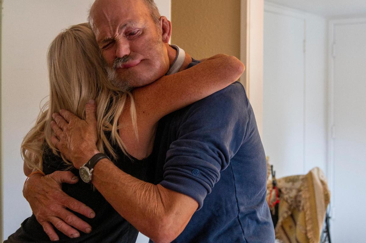 Jim Wilson, hugs his friend Meitra Bozorgzadegan, who has helped him through throat cancer surgery and advocated to get him permanent housing, on Friday June 12, 2020.