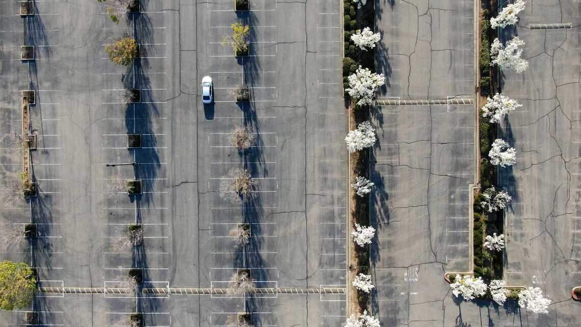 Is it against the law to cut through a parking lot to avoid a red light in California?