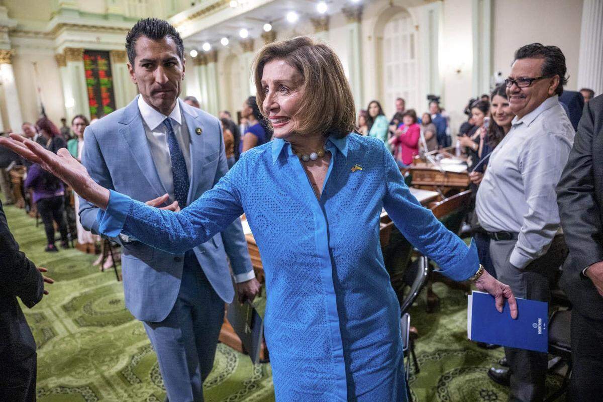 U.S. House Speaker Emerita Nancy Pelosi leaves the Assembly floor with Assembly Speaker Robert Rivas on June 30, 2023, after his swearing in ceremony at the state Capitol in Sacramento.