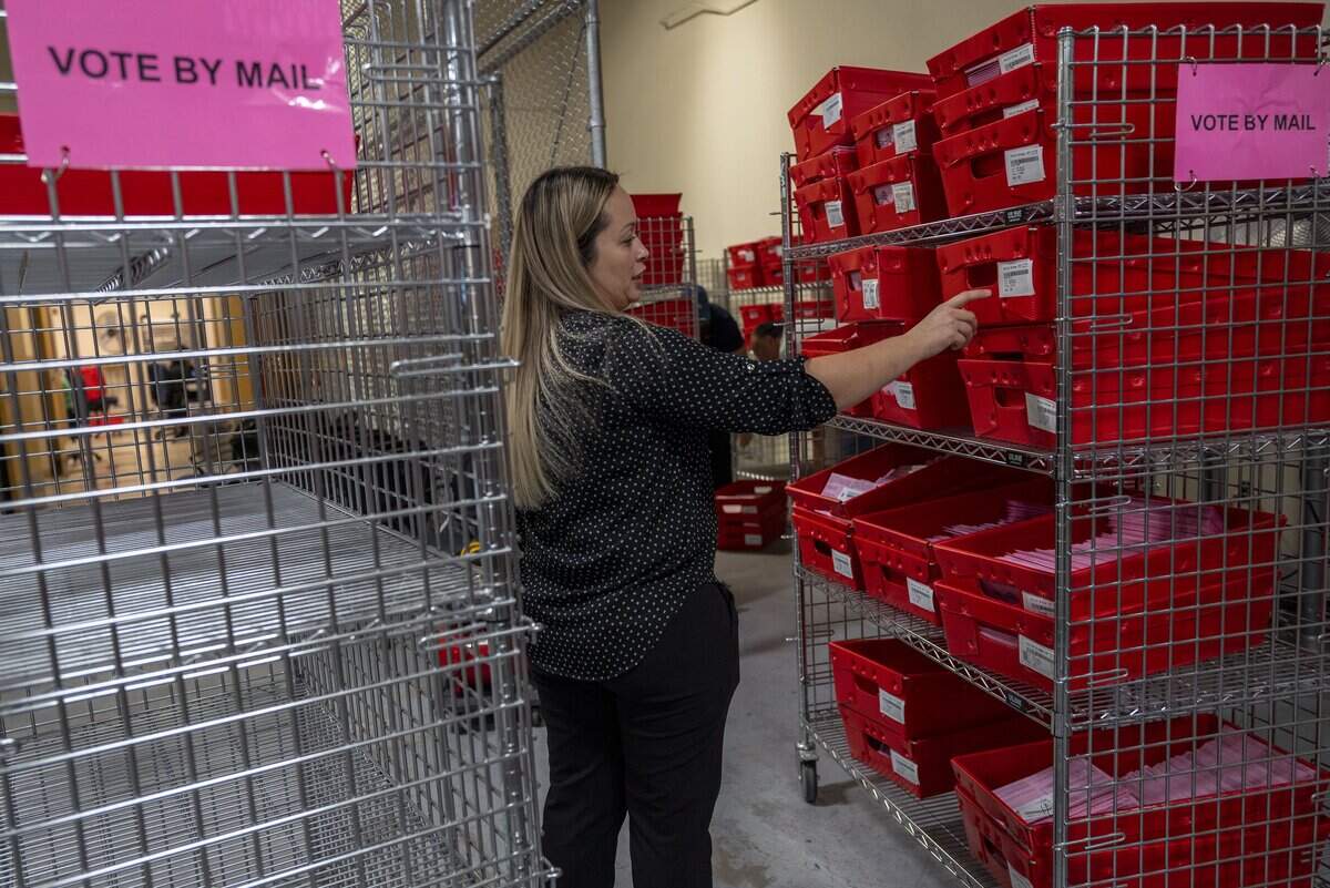 Election Manager Karalyn Fox looks over ballots received by mail on Thursday, Nov. 3, 2022, at the Sacramento County elections office.