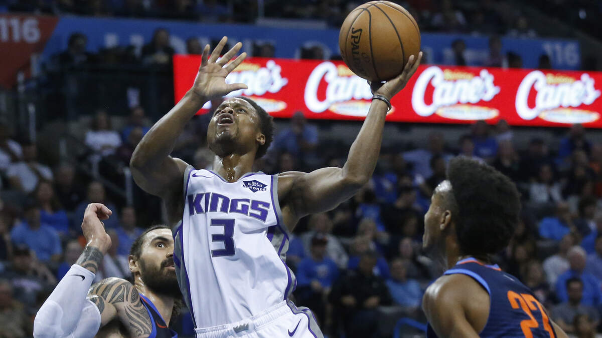 Sacramento Kings guard Yogi Ferrell (3) shoots between Oklahoma City Thunder center Steven Adams, left, and guard Terrance Ferguson (23) in the first half of an NBA basketball game in Oklahoma City, Sunday, Oct. 21, 2018. (AP Photo/Sue Ogrocki)