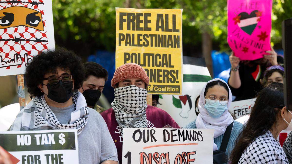 Members of the Sacramento State chapter of Students for Justice Palestine chant after a campus press conference on May 8 about the university’s decision to alter its investment policy language. The group has been camped out on the library quad since late last month, calling for disclosure of any university ties to Israel and divestment if such ties exist.