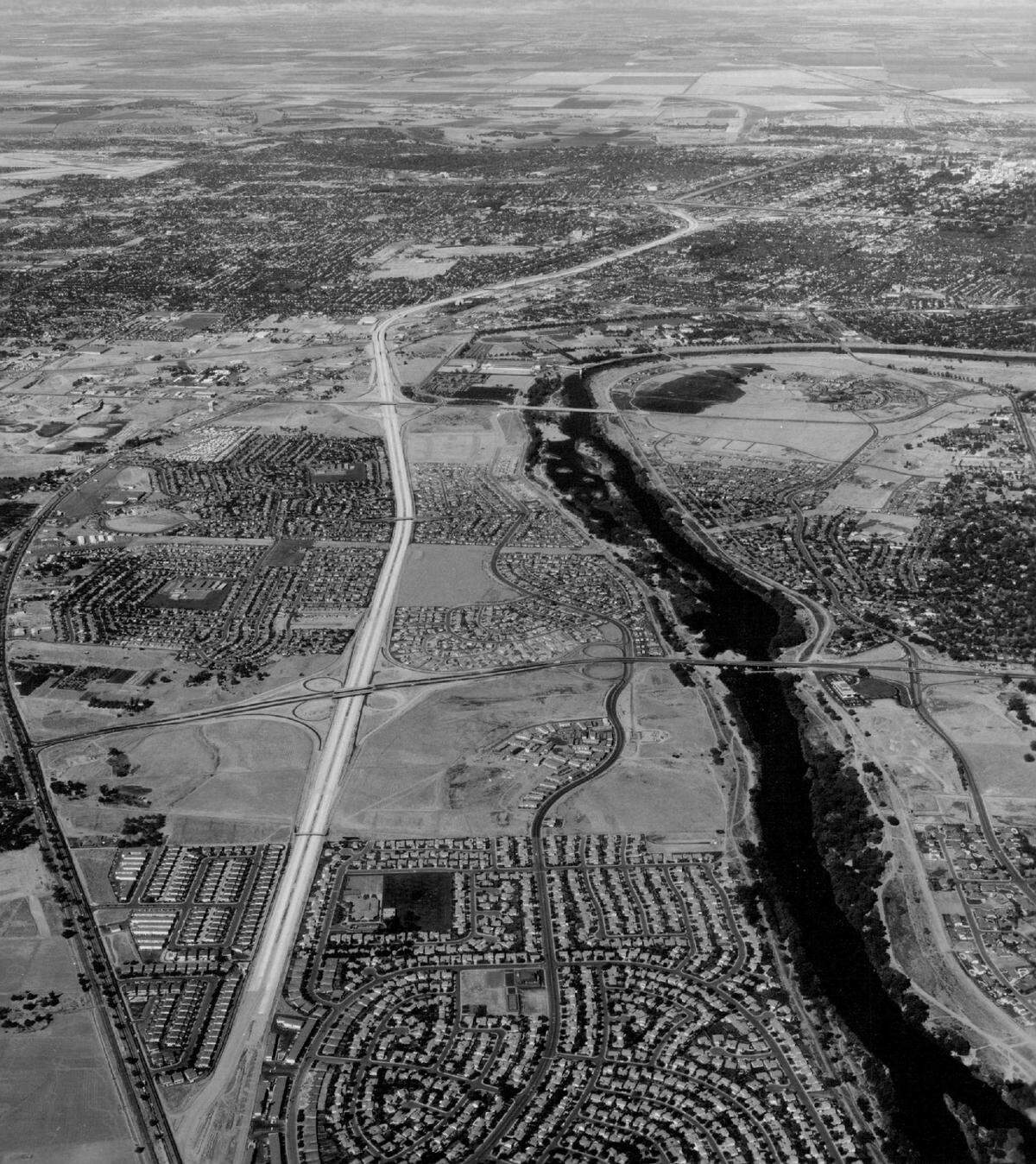 Construction of Highway 50 freeway east of Sacramento is underway in October 1971. Bridges cross the American River at Howe Avenue and Watt Avenue, bottom, in this picture. 