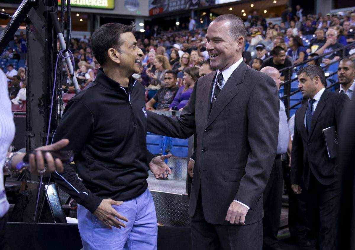 The Sacramento Kings owner Vivek Ranadive talks with then-head coach Michael Malone before the team’s preseason game against the Los Angeles Clippers in 2013 at Sleep Train Arena.