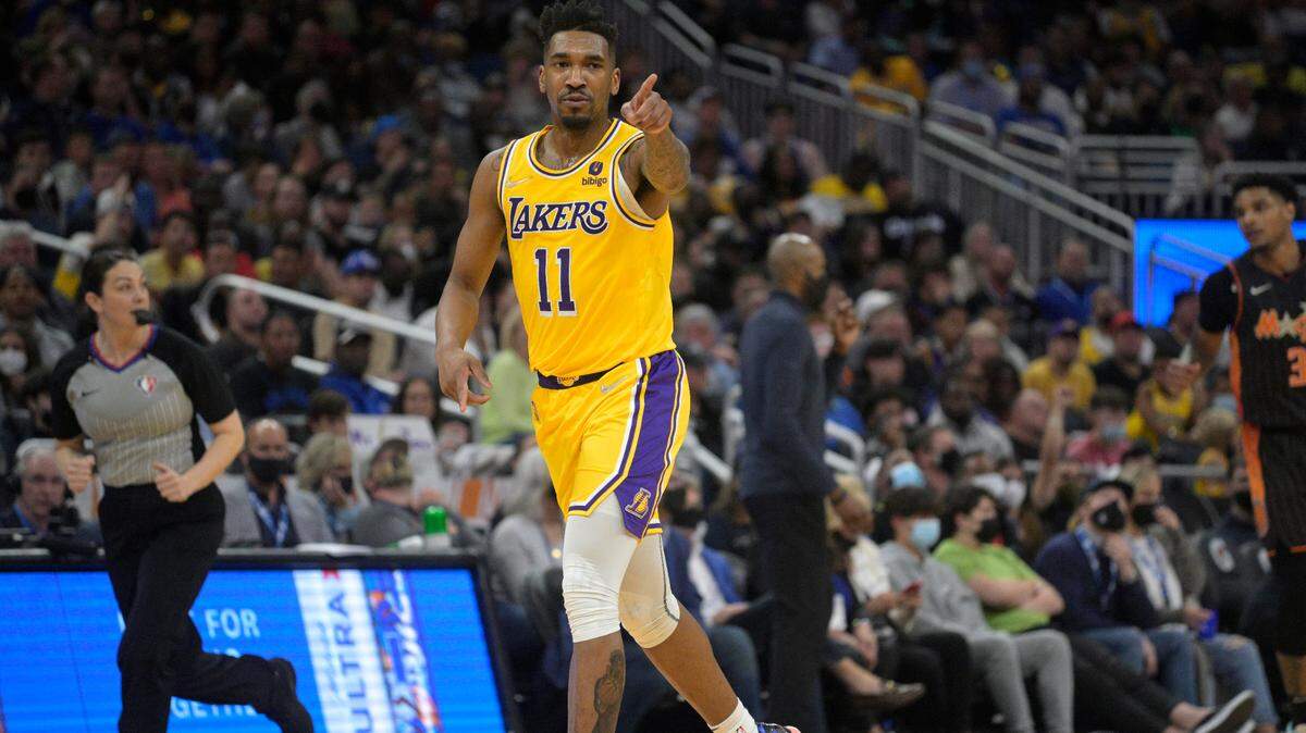 Los Angeles Lakers guard Malik Monk (11) reacts after scoring during the second half of an NBA basketball game against the Orlando Magic, Friday, Jan. 21, 2022, in Orlando, Fla. (AP Photo/Phelan M. Ebenhack)