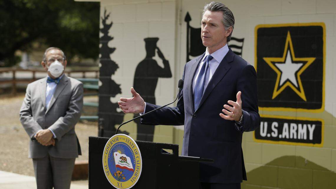 California Gov. Gavin Newsom gestures during a news conference as CalVet Secretary Vito Imbasciani looks on at the Veterans Home of California, Friday, May 22, 2020, in Yountville, Calif. (AP Photo/Eric Risberg, Pool)