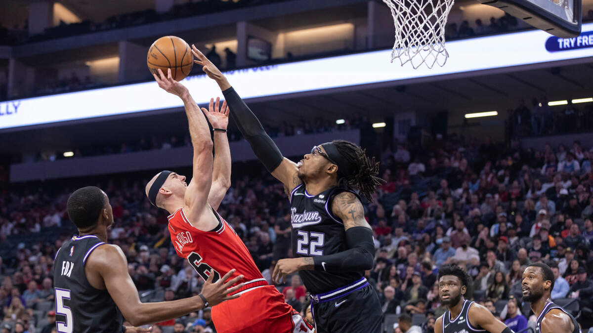 Sacramento Kings center Richaun Holmes (22) blocks the shot of Chicago Bulls guard Alex Caruso (6) during the second quarter on Monday, March 14, 2022 during an NBA basketball game at the Golden 1 Center in Sacramento. The Kings defeated the Bulls 112-103.