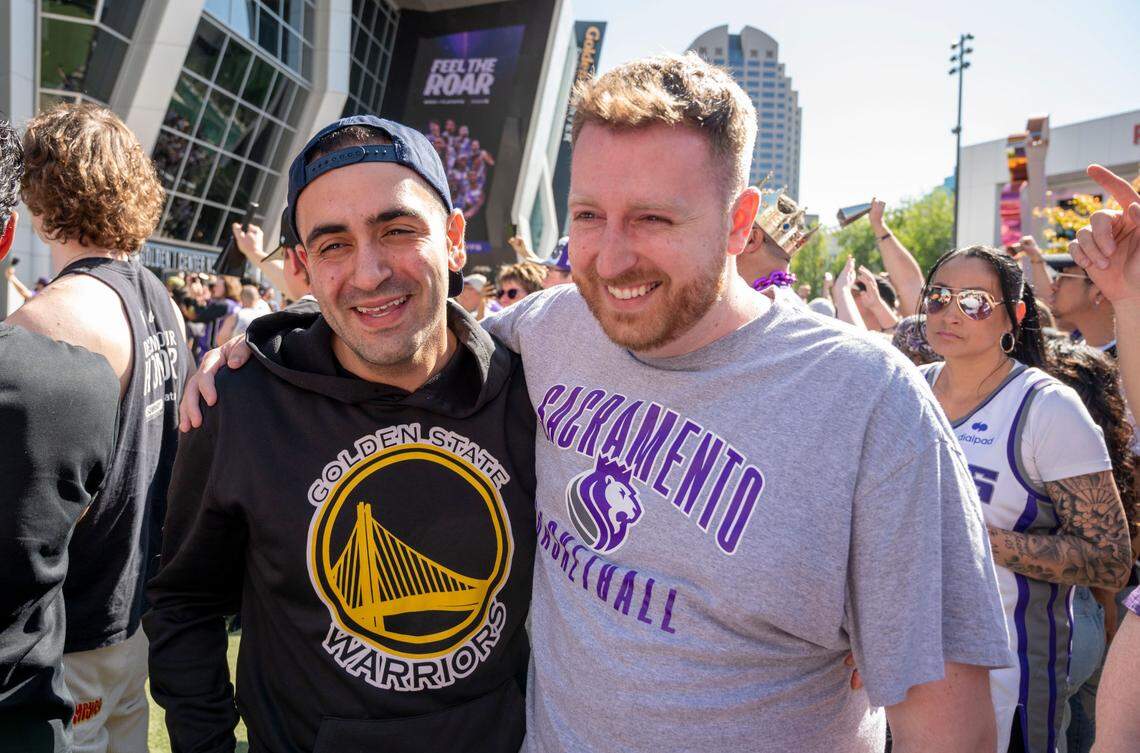 Paul Payam of San Francisco, a Warriors fan, stands with his friend Brian Farmer, a Kings fan, outside Golden 1 Center before the first playoff game Saturday, April 15, 2023. It was Farmer’s 30th birthday.