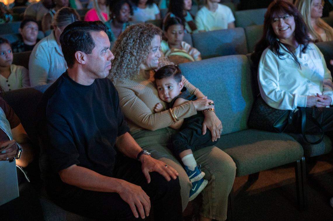 The Rev. Samuel Rodriguez Jr. and his wife and co-pastor Eve Rodriguez, sit together with their grandson, Beckham Aleman, 1, while listening to music earlier this month at New Season Church.
