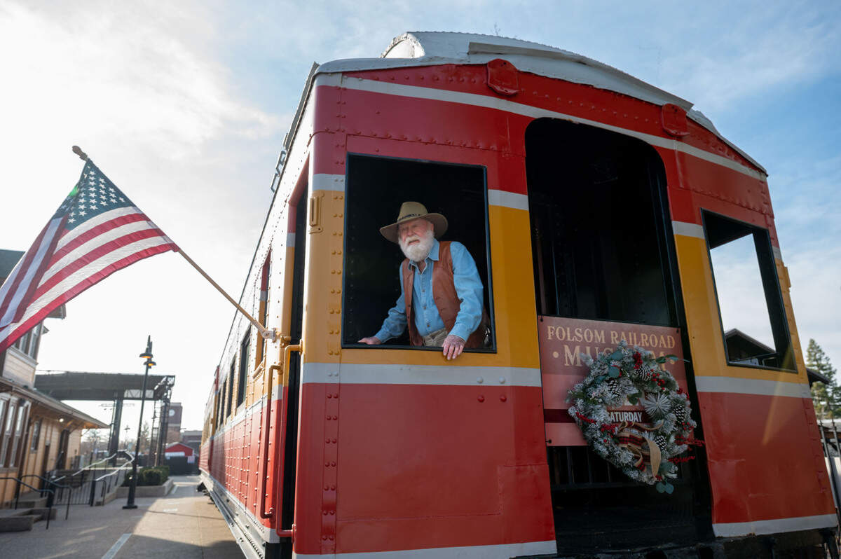 Bill Anderson stands in the window of the Folsom Train Museum earlier this month. The founding president of the Folsom, El Dorado & Sacramento Historical Railroad Association in 1995, Anderson now leads the city’s railroad museum in the historic district.