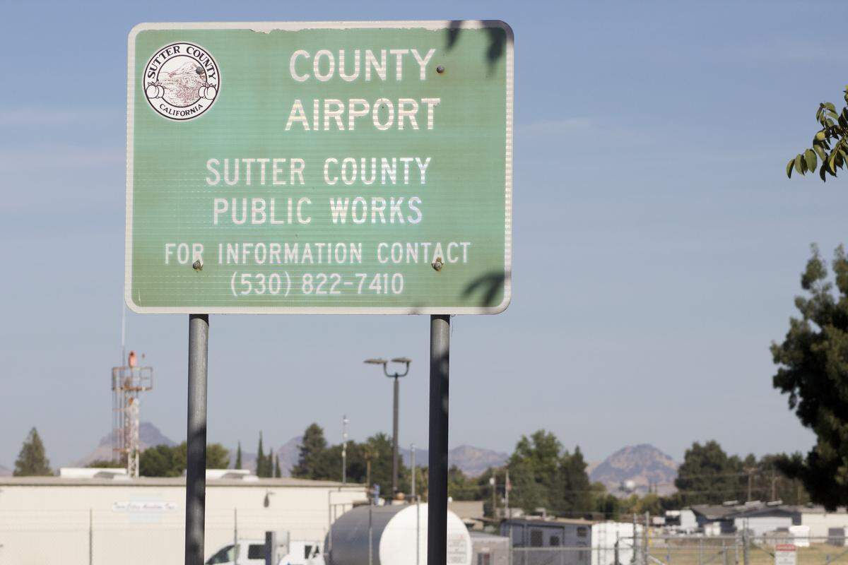 The Sutter Buttes lie behind a sign at the entrance to the Sutter County Airport. A grand jury recently determined that Sutter County has passed on up to $15 million in federal funding over the past decade. County officials refute that estimate.