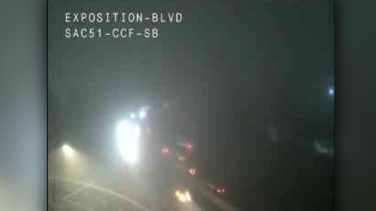 Caltrans cameras at Exposition Boulevard capture early morning commuters navigating dense fog on Highway 51 on Friday, Jan. 23.