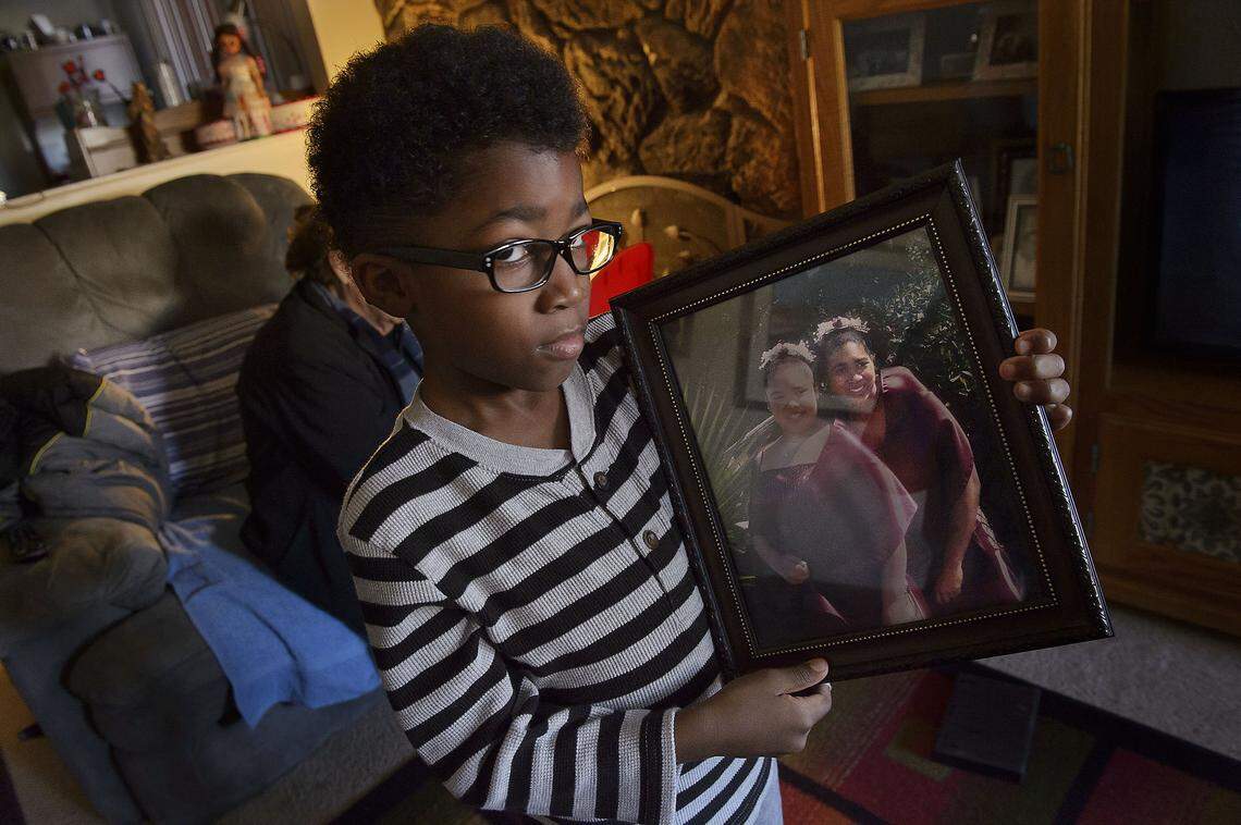 Vincent Nevarez 6, holds a photo of his mother Gabriella Nevarez (at right in photo) at his home in Citrus Heights on Thursday, February 23, 2017. Gabriella Nevarez was killed by Citrus Heights police in 2014.
