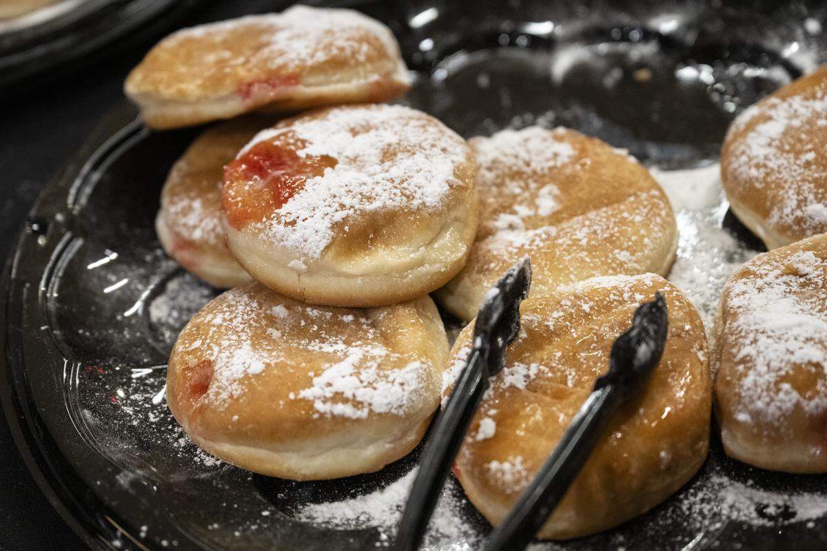 Jelly filled donuts are served at a menorah lighting on the first night of Hanukkah at the Westfield Galleria in Roseville on Sunday.