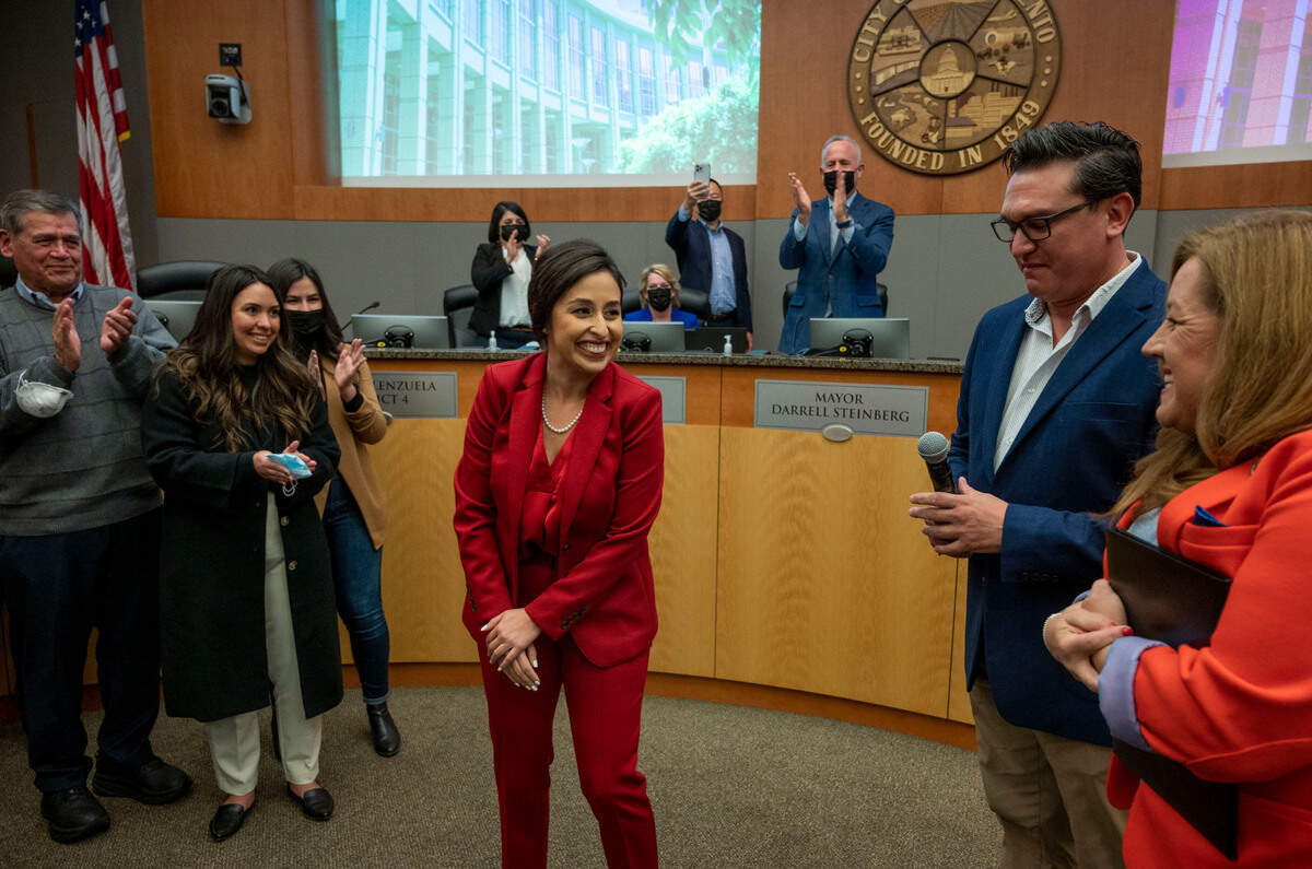 Karina Talamantes stands with family members and smiles at Angeliique Ashby, on Tuesday after being sworn in as one of the newly-elected members of the Sacramento City Council.