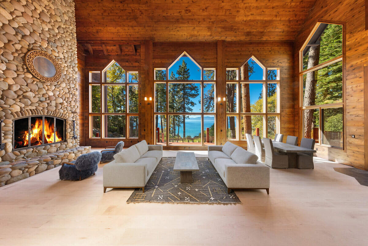 Skylights, wood accents, and a dramatic floor-to-ceiling stone fireplace create a warm, artistic retreat, crowned by a spa suite with sauna, indoor hot tub, and cold plunge.