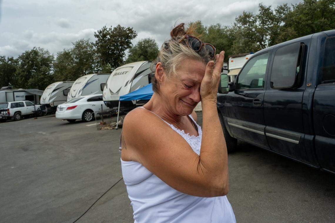 Jeanne Gillis walks through Camp Resolution distraught on Friday. She said she has lupus and it affects her kidneys, lungs and brain and she suffers seizures. She said that the Sacramento Department of Community Services took her information and said they would get back to her. She said she can't go to the Roseville Road shelter because, without electricity to cool her space, her seizures will get worse. "I will die," she said.