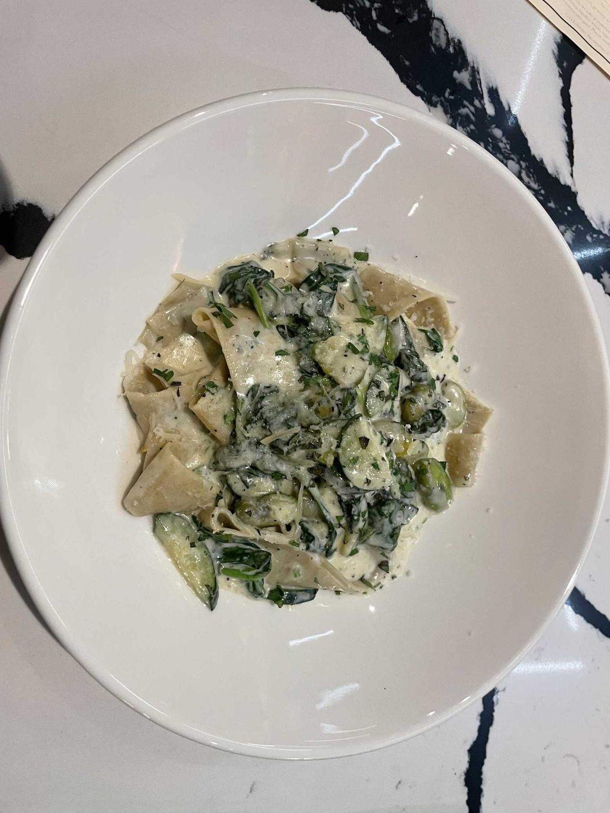 Field-n-Flame Midtown Restaurant’s house-made pappardelle dish includes house-made pappardelle pasta with fava beans, spinach, and zucchini in a velvety garlic cream sauce, finished with shaved pecorino. The plate is $26.