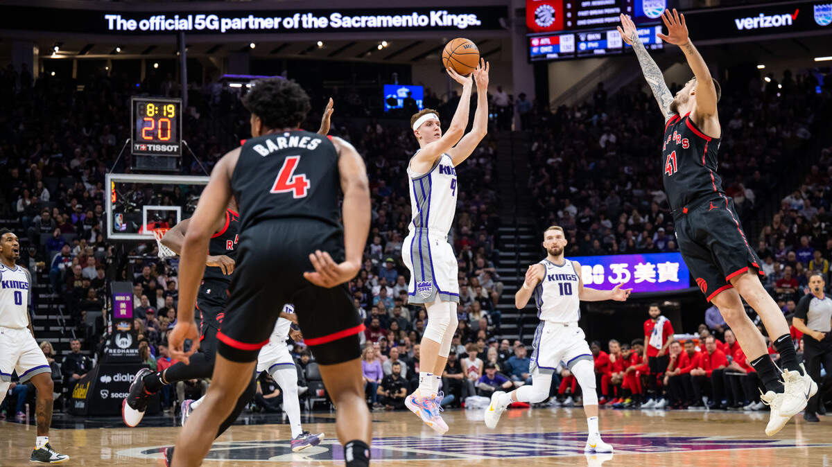 Sacramento Kings guard/forward Kevin Huerter (9), center sinks a three point basket over a defending Toronto Raptors forward Juancho Hernangomez (41) during the second quarter of the NBA basketball game Wednesday, Jan. 25, 2023, at Golden 1 Center in Sacramento.