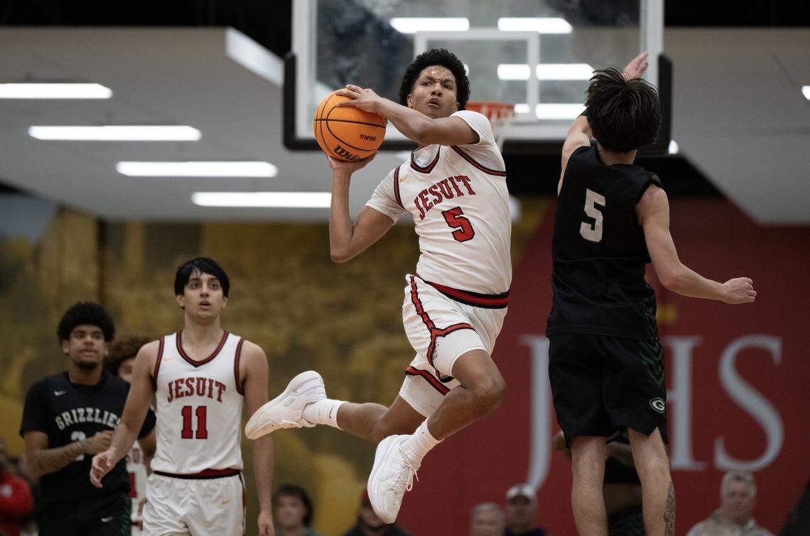 The Jesuit Marauders' Maison Phillips (pus up a shot at the end of the third quarter in front of the Granite Bay Grizzlies' Keegan Ladines (5) on Wednesday, Jan. 7, in Carmichael.