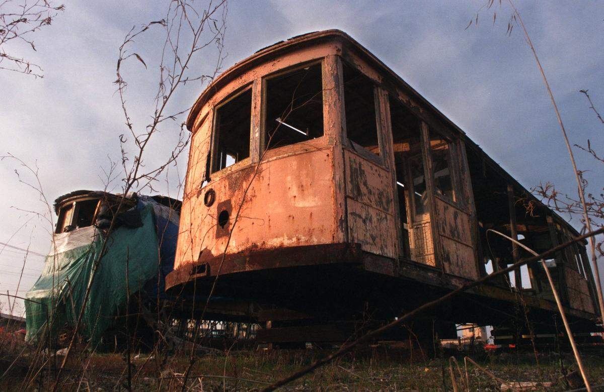 Two historic Sacramento streetcars sit on wood blocks, deteriorating with the weather in an East Sacramento yard in 1999. In the early 1940s, streetcars were a part of the Sacramento landscape but by the end of that decade they became history. 