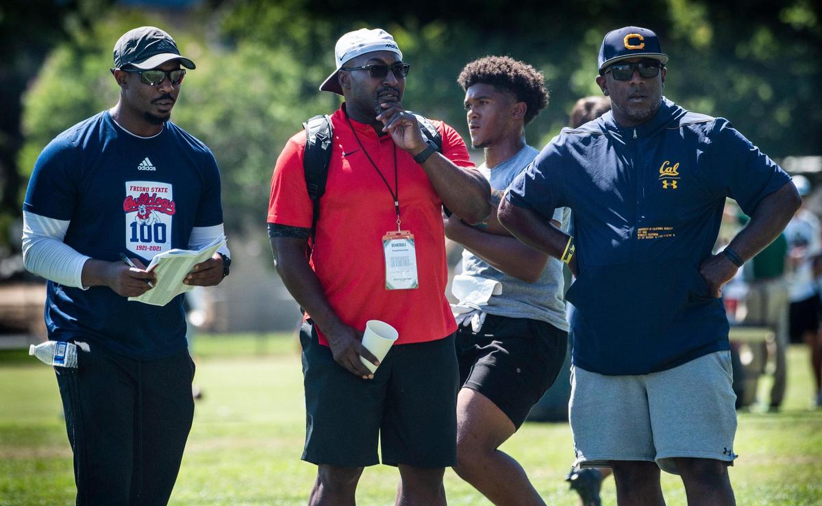 College running backs coaches James Montgomery (Fresno State), Scotty Graham (Arizona) and Aristotle Thompson (Cal) keep an eye on players Wednesday during a high school football skills camp at Sacramento State.