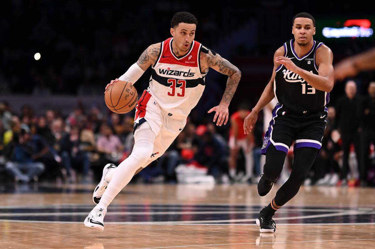 Washington Wizards forward Kyle Kuzma (33) drives to the basket as Sacramento Kings forward Keegan Murray (13) defends during the second half March 21, 2024, at Capital One Arena in Washington, D.C.