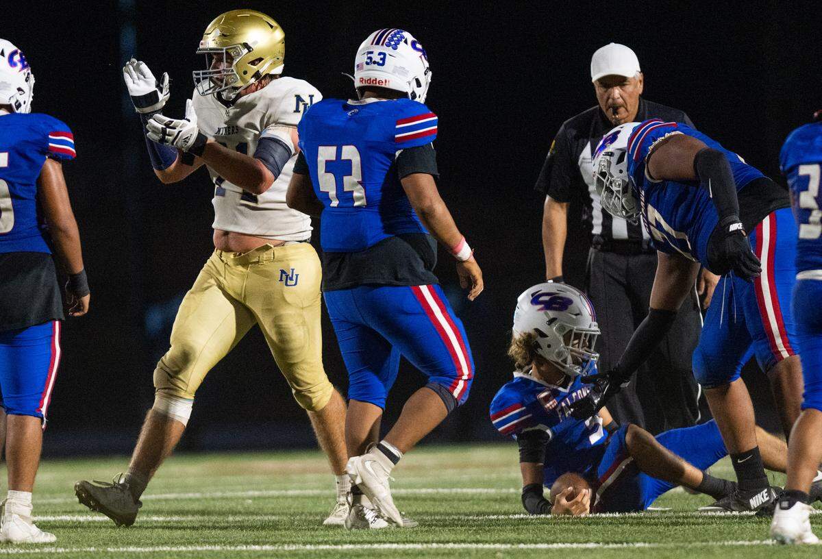 The Nevada Union Miners' Craig Statler (71) celebrates after sacking Christian Brothers Falcons quarterback Deakon Holden (3) in Sacramento on Friday.