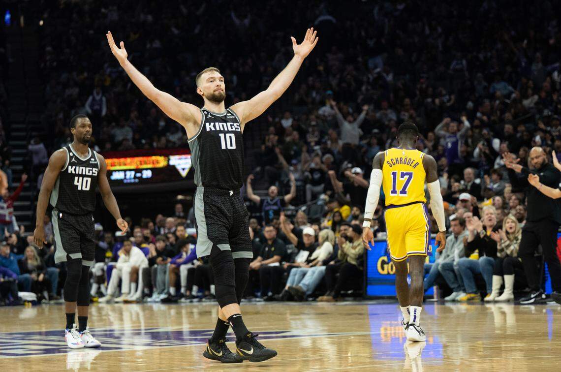 Sacramento Kings forward Domantas Sabonis (10) reacts after Sacramento Kings forward Harrison Barnes (40) hits a three point basket in the fourth quarter during a game at Golden 1 Center in Sacramento, Wednesday, Dec. 21, 2022.