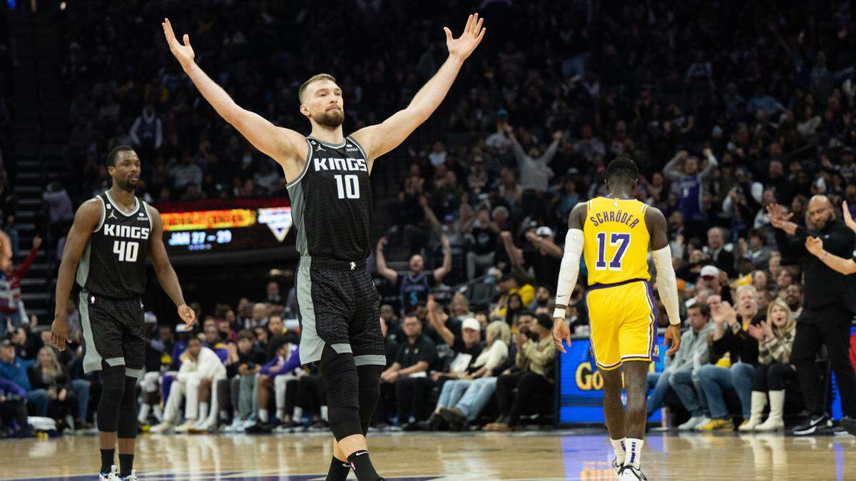 Sacramento Kings forward Domantas Sabonis (10) reacts after Sacramento Kings forward Harrison Barnes (40) hits a three point basket in the fourth quarter during a game at Golden 1 Center in Sacramento, Wednesday, Dec. 21, 2022.