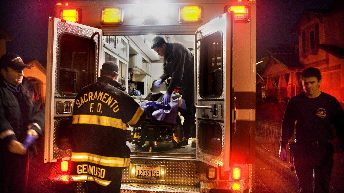 Sacramento Fire Department personnel from Station 30 load a patient into an ambulance in 2009 in North Natomas. A city audit found that nearly 40% of emergency medical calls handled by the department between July 2023 and June 2024 were low-acuity incidents that posed no immediate threat, contributing to delays and nearly $5 million in added costs.