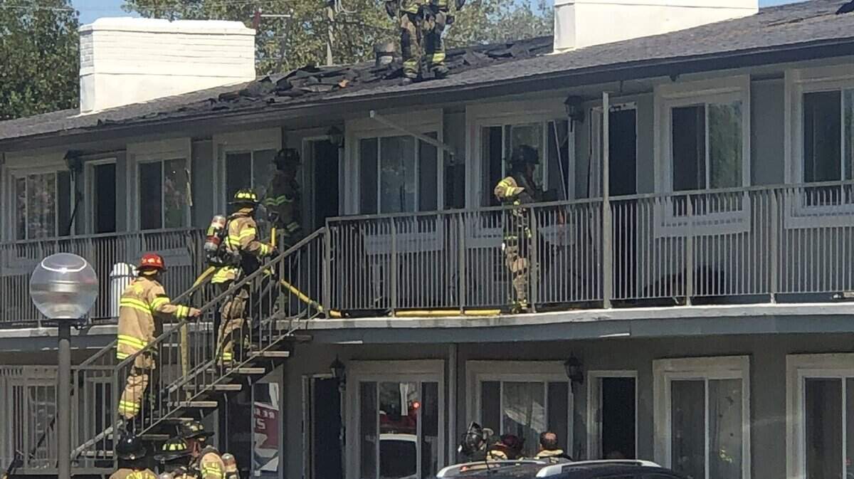 Fire crews attend to a fire at a two-story apartment building Sunday, July 24, 2022, off Little Oak Lane in Foothill Farms.