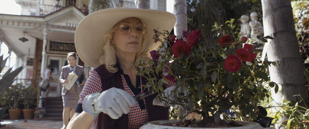 Susan Priver, who stars as notorious Sacramento killer Dorothea Puente in the horror film “Dorothea,” clips roses outside the Queen Anne Victorian located on the east side of Los Angeles that stands in for her residence in the movie.