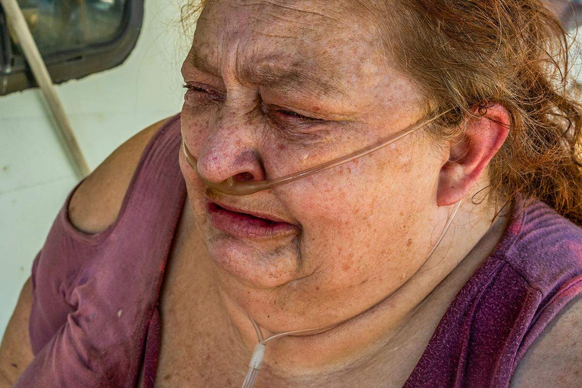 Tears stream down the face of Camp Resolution resident Shonn Adams as she describes the uncertainty of their homeless encampment on Aug. 5. “People don’t care anymore,” she said. “There aren’t enough places or shelters or anything else either. They are going to throw us back in the streets and punish us more for being homeless.”