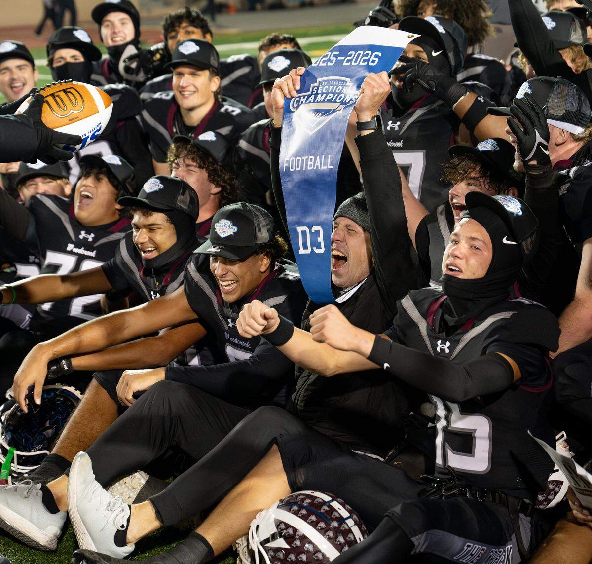 Woodcreek players celebrate after their 58-52 win over Oakdale for the Sac-Joaquin Section Division III championship at Hughes Stadium in Sacramento, Friday, Nov. 28, 2025. 