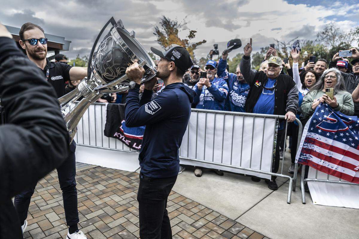 Kyle Larson pretends to drink from the Bill France Cup, the trophy awarded to the winner of the NASCAR Cup Series Championship, as he’s celebrated on Friday in his hometown of Elk Grove. Larson won his second NASCAR championship earlier in the month. 