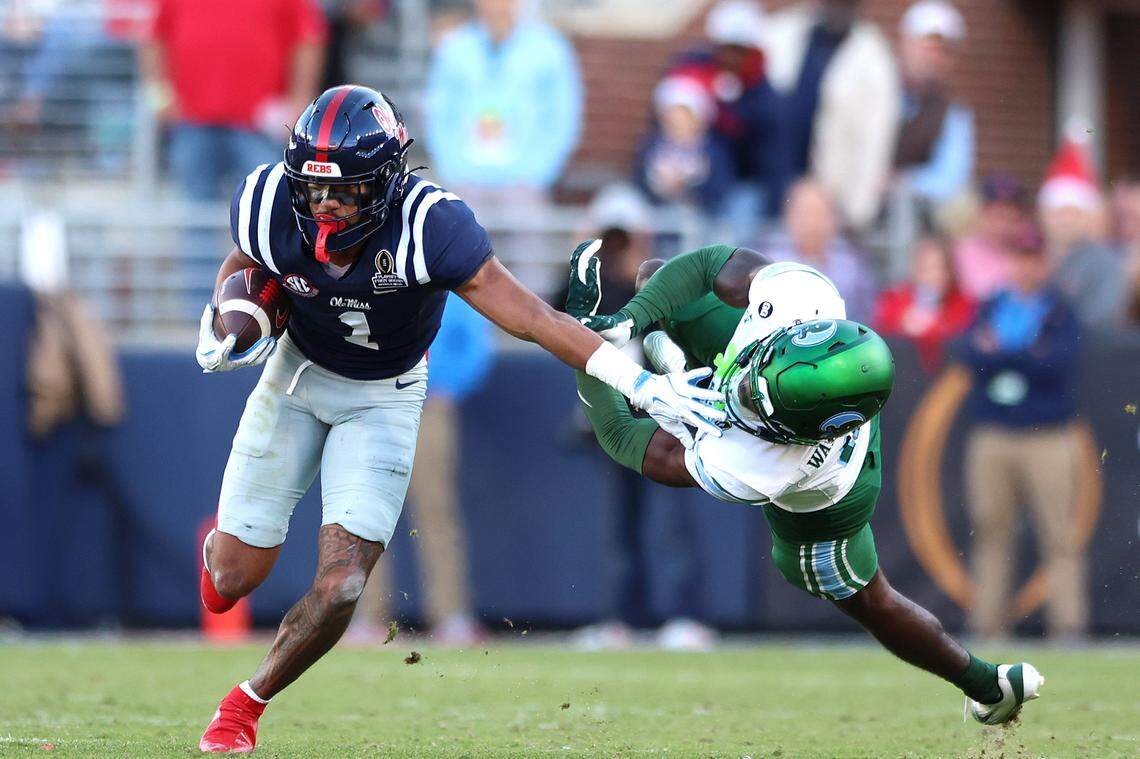OXFORD, MISSISSIPPI - DECEMBER 20: De'Zhaun Stribling #1 of the Ole Miss Rebels stiff arms Isaiah Wadsworth #8 of the Tulane Green Wave during the second quarter of the 2025 College Football Playoff First Round Game at Vaught-Hemingway Stadium on December 20, 2025 in Oxford, Mississippi. (Photo by Wes Hale/Getty Images)