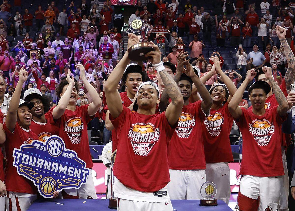 Darius Acuff Jr. (5) of the Arkansas Razorbacks hoists the Most Valuable Player trophy after defeating the Vanderbilt Commodores 86-75 in the 2026 SEC Men’s Basketball Tournament Championship game at Bridgestone Arena on March 15, 2026 in Nashville, Tennessee.