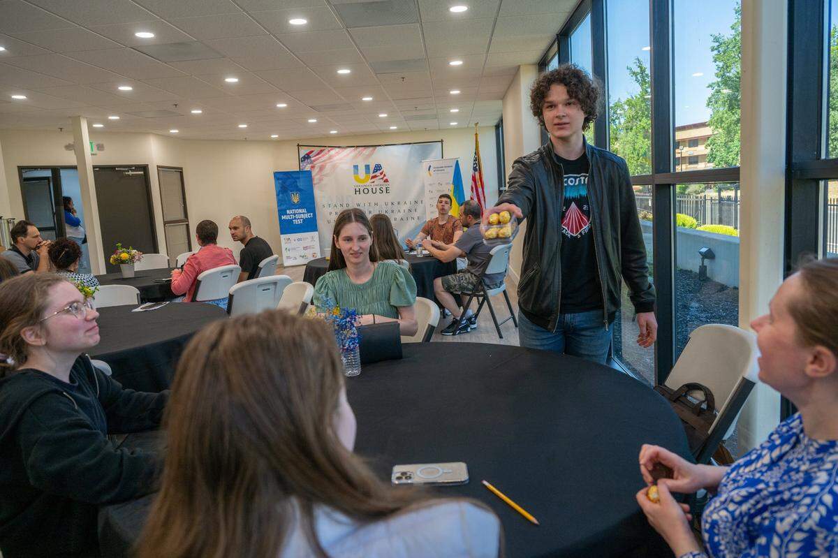 Viva Kuchera, 17, passes out chocolate to other students who completed their National Multi-subject Test, or NMT, for Ukrainian refugee high school graduates seeking to further their educational goals on Tuesday at the Ukrainian American House in Rancho Cordova. “I took this test only because there is an actual probability that I will go back to Ukraine, depending on the U.S. elections,” Kuchera said.
