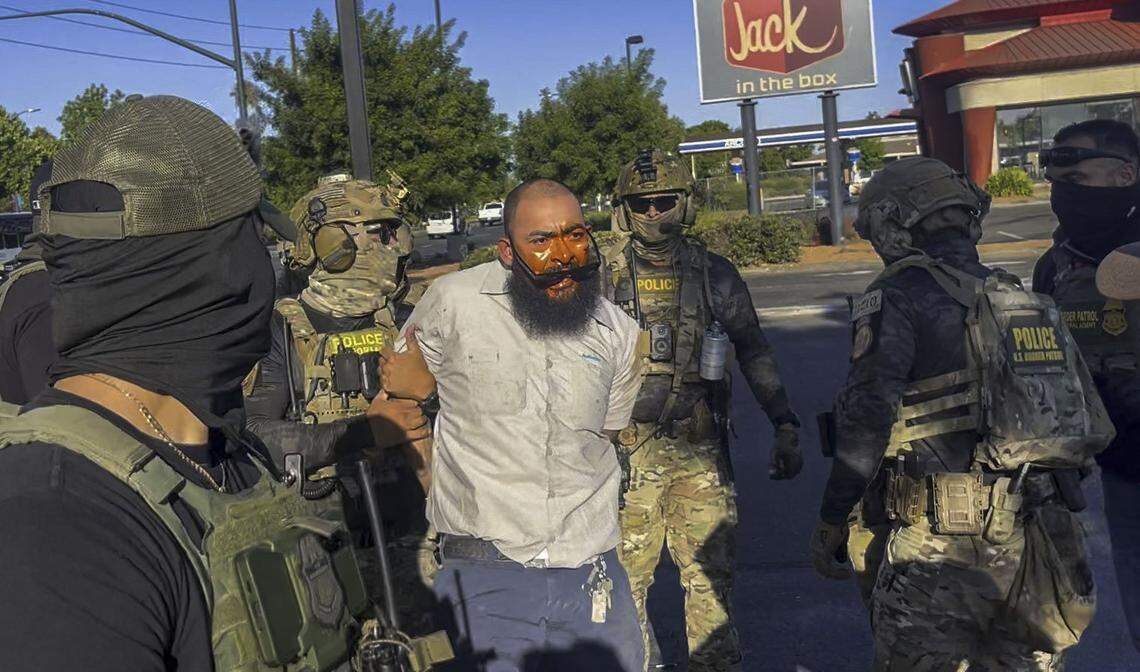 In an image from video, Jose Castillo is detained by U.S. Border Patrol officers at the Florin Road Home Depot in south Sacramento on July 17, 2025. Castillo’s wife Andrea said he is a U.S. citizen who was recording the actions of the masked federal agents.