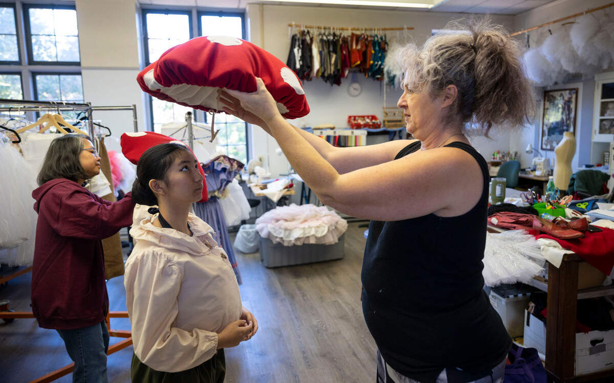 Maddie Toledo, 13, is fitted with a mushroom top hat by assistant costume designer Sue Everett prior to cast photo sessions for "The Nutcracker" at the Sacramento Ballet studios in midtown on Nov. 4.