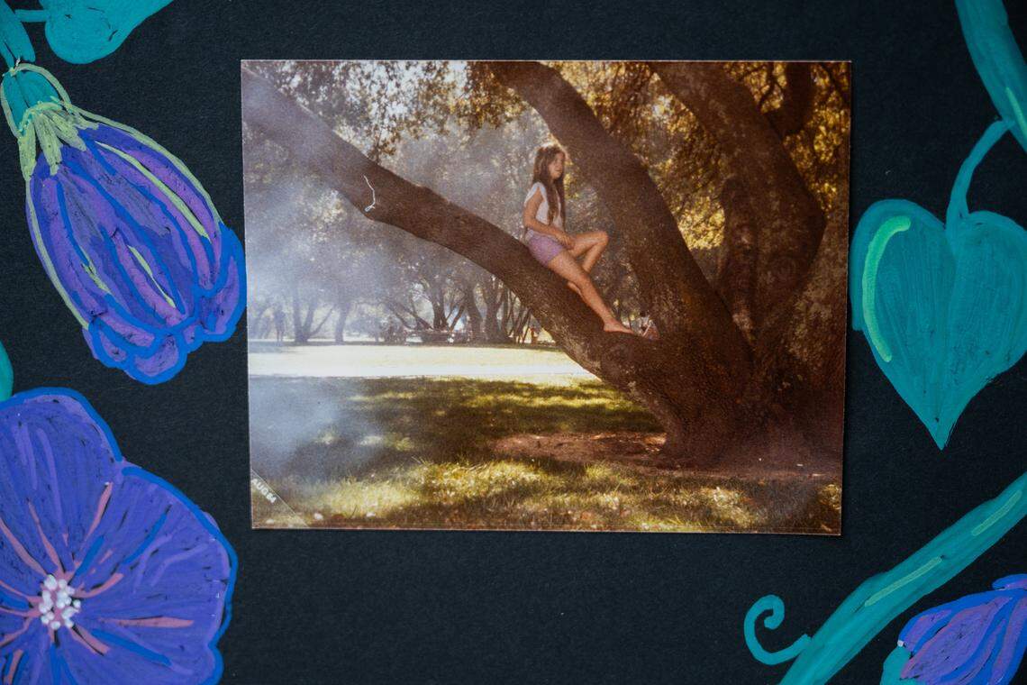 A family photograph shows Candyce Dysinger sitting in her favorite tree as a teenager. It was incorporated into a display of photos that her sister Rytina Heyne displayed in October. Heyne said her family held a memorial under the tree after Dysinger died of a drug overdose at age 51 at the Florin Road Safe Stay Shelter.