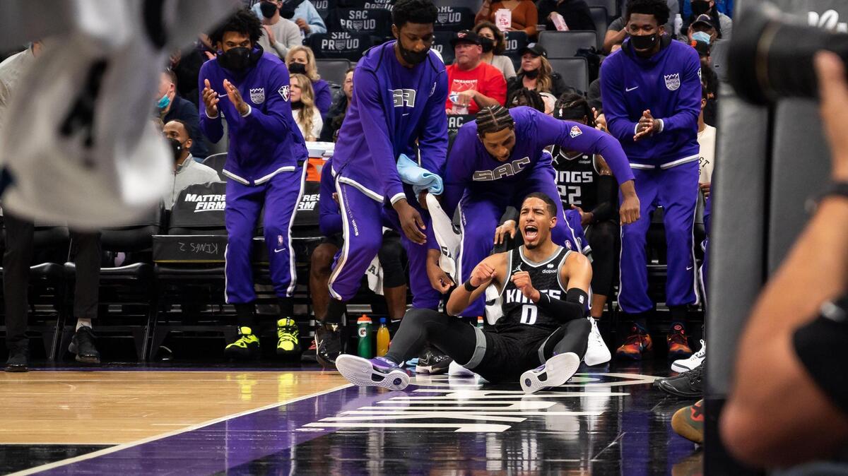 Sacramento Kings guard Tyrese Haliburton (0) yells from the floor and is helped up by teammates after being fouled on defense by the Utah Jazz during the first half of their NBA regular season home opener Friday, Oct. 22, 2021, at Golden 1 Center in downtown Sacramento.