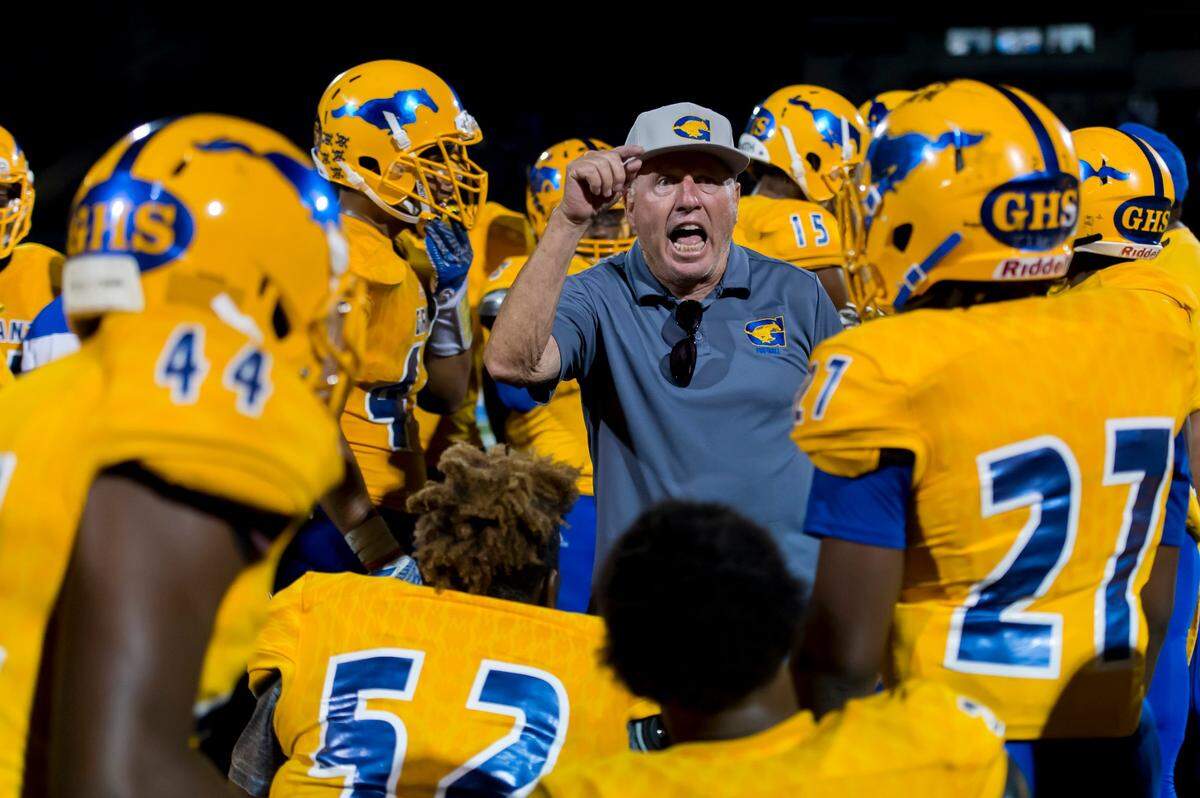 Grant High School football coach Mike Alberghini talks with his offensive squad before a game with Paradise High School at Grant in Sacramento on Aug. 24, 2012.