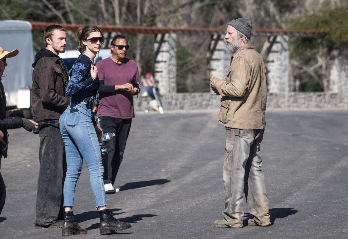 Actor Xander Berkeley, right, dressed for his role of Harris in the film “No Address,” stands near the William Land Park rock garden during a filming day on Wednesday. The movie is based on stories about homeless people and Berkeley, who is also an artist, is painting portraits of the actors that will be auctioned to help charities in the Sacramento area.