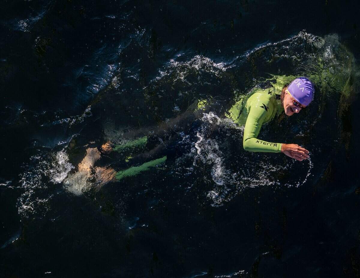 Corbin Bargain of San Carlos swims near the Jibboom Street Bridge on the American River during the Ironman California triathlon in Sacramento on Sunday, Oct. 23, 2022.