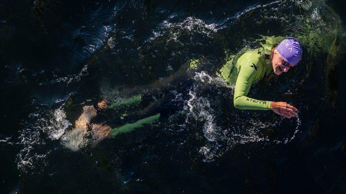 Corbin Bargain of San Carlos swims near the Jibboom Street Bridge on the American River during the Ironman California triathlon in Sacramento on Sunday, Oct. 23, 2022. April temperatures are still too cold to swim safely in Northern California rivers, the weather service warns.
