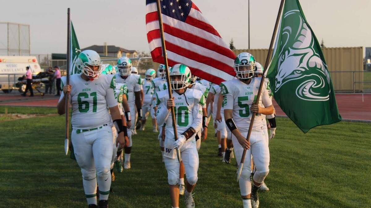 Dixon players carry flags onto the field for Thursday’s game with Casa Roble