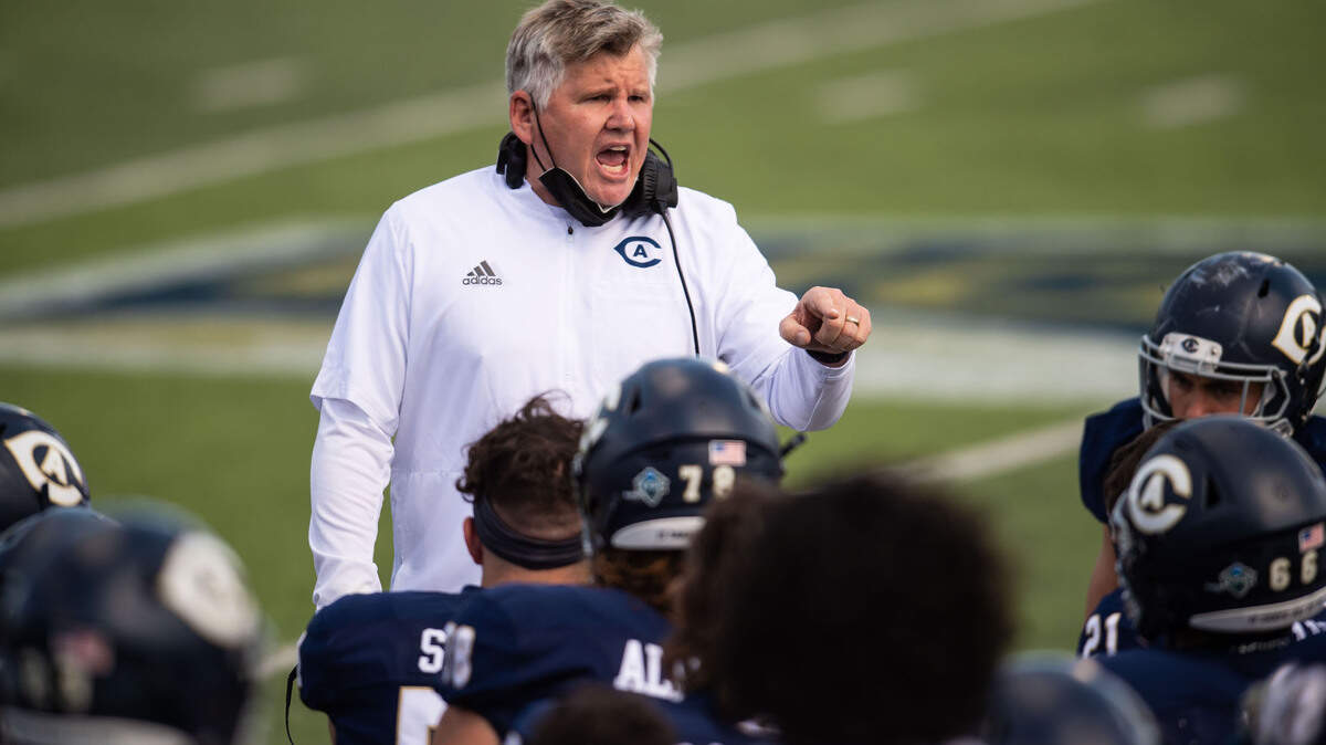 UC Davis head coach Dan Hawkins talks to his players going into halftime with a big lead over Cal Poly during the Aggies’ first home football game of the spring season Saturday, March 20, 2021, in Davis.