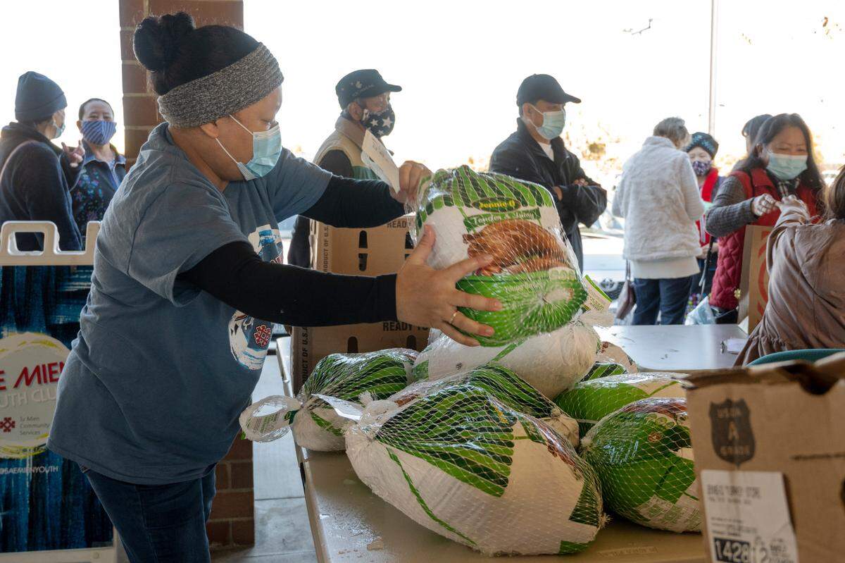 Meay Saeteurn, operations supervisor, sets out frozen turkeys for distribution at the Stockton Boulevard Partnership Thanksgiving grocery giveaway for seniors of the lu Mien community Saturday, Nov.. The Center is hoping Book of Dreams readers can help raise $5,000 to help provide one grocery bag per month for every senior in need throughout the winter.